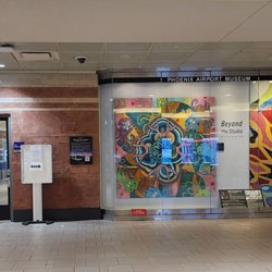 Global Entry Enrollement Center - US CUSTOMS OF HOMELAND SECURITY  US CUSTOMS AND BORDER PROTECTION  The door is to the left of the Phoenix Airport Museum display
