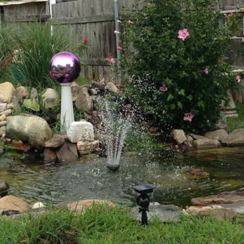 Derek's Landscaping - A custom designed water feature with koi fish in the pond. They have it running year round including the winter. - Landscaping Near Me Derek's Landscaping - A custom designed water feature with koi fish in the pond. They have it running year round including the winter. - Landscaping Near Me