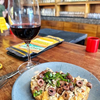 Postino Arcadia - Seasonal bruschetta; toasted almond hummus topped with tuna (Mayo free), and Kalamata olives. Must try this season! - Wine Bars Near Me - Phoenix, Arizona Postino Arcadia - Seasonal bruschetta; toasted almond hummus topped with tuna (Mayo free), and Kalamata olives. Must try this season! - Wine Bars Near Me - Phoenix, Arizona