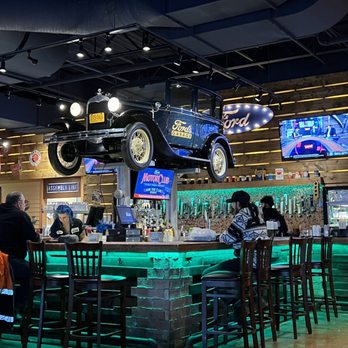 Ford's Garage Dearborn - Bar area with a car hanging from the ceiling - Burgers Near Me - Dearborn, Michigan Ford's Garage Dearborn - Bar area with a car hanging from the ceiling - Burgers Near Me - Dearborn, Michigan