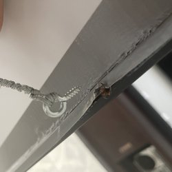 Frame wire completely ripped out of the frame because they didn't pre-drill the hole and frame was cracked