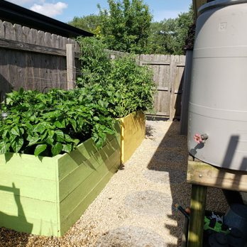 Emerald Bloom Landscaping - a garden with a rain barrel - Landscaping Near Me - Mokena, Illinois