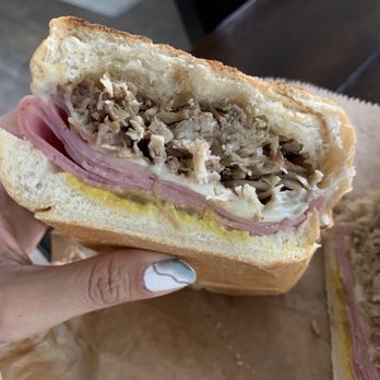 Mobile Cuban Cafeteria - a hand holding a sandwich - Food Trucks Near Me - Boca Raton, Florida