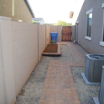 Alrey's Landscaping - a brick walkway between two buildings - Landscaping Near Me