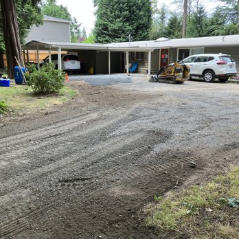 Custom Scapes - a driveway being laid in front of a house - Landscaping Near Me