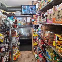 Economy Market & Carry-Out - Merchandise, carryout counter, and security monitor.