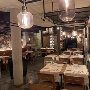 Sagardi Cozinheiros Bascos - Lower level beautiful dining room. The lighting and original granite walls made it feel very intimate - Restaurants Near Me - Porto, 13