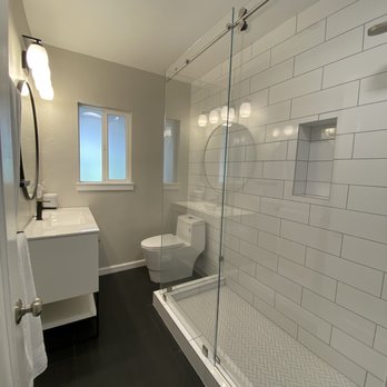 Banner Construction - a bathroom with a shower, toilet and sink - General Contractors Near Me
