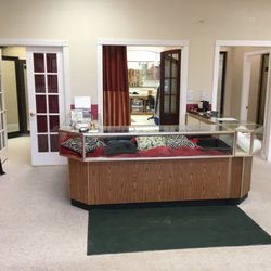Amporn's Tailoring - Front Counter with custom pillows in showcase.