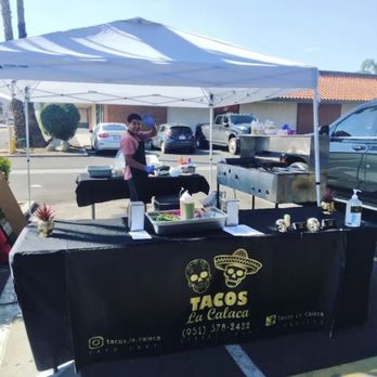 Tacos La Calaca - a taco stand in a parking lot - Tacos Near Me