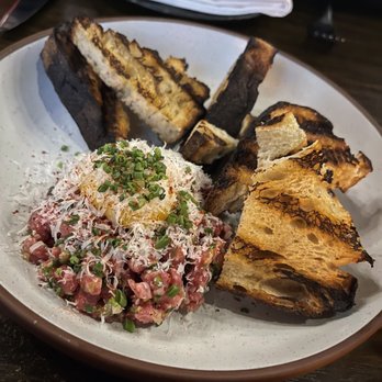 Sparrow + Wolf - GRASS FED BEEF TARTARE, EGG YOLK, GRILLED (burnt) SOURDOUGH - New American Near Me - Las Vegas, Nevada Sparrow + Wolf - GRASS FED BEEF TARTARE, EGG YOLK, GRILLED (burnt) SOURDOUGH - New American Near Me - Las Vegas, Nevada