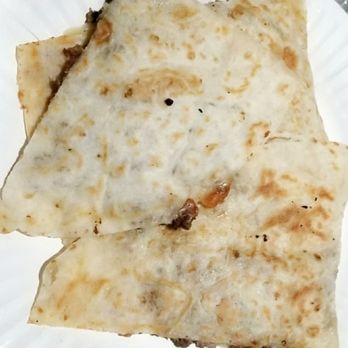 Tacos Los Cuñados - a hand holding a paper plate of quesadillas - Tacos Near Me Tacos Los Cuñados - a hand holding a paper plate of quesadillas - Tacos Near Me