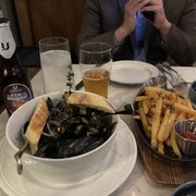 Photo of Kendall's Brasserie - Los Angeles, CA, United States. Shareable mussels and fries Belgian beer