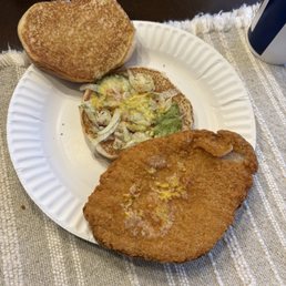 Pork sandwich either very little lettuce, ketchup, mustard and 1 pickle