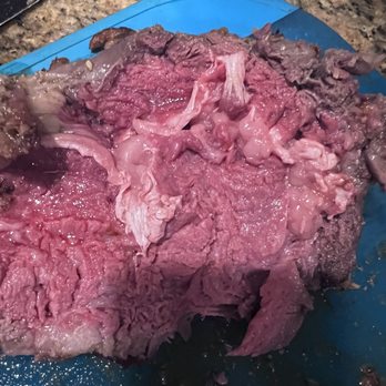 Five Points Meat Market - a close up of a piece of meat on a blue cutting board - Butcher Near Me - Ventura, California