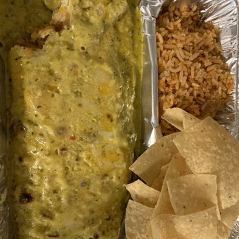Chuy's - Sorry, I had to take a bite before the pic. pictured is the Big as yo face burrito  with boom boom sauce. - Tex-Mex Near Me - Lubbock, Texas