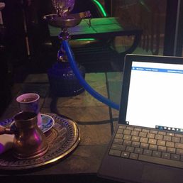 a laptop and a hooket on a table