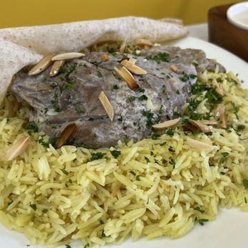 Yalla Nakol - a plate of food with rice and meat - Middle Eastern Near Me - Windsor, Ontario