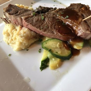 Grains & Grill - 1/2 portion of 16oz prime rib, delicious to perfection!  Mashed Potatoes & zucchini also perfect! - American Near Me - Fairmount, Indiana