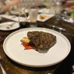 Rib eye steak (14oz) on roasted vegetables and mashed potatoes. Rib eye steak (14oz) on roasted vegetables and mashed potatoes.