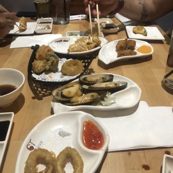 Sushi Taku - Whats left of 2 orders of Fried calamari (bottom plate and the black basket) Baked muscles Gyoza (fried-top left) - Japanese Near Me - Chicago, Illinois Sushi Taku - Whats left of 2 orders of Fried calamari (bottom plate and the black basket) Baked muscles Gyoza (fried-top left) - Japanese Near Me - Chicago, Illinois