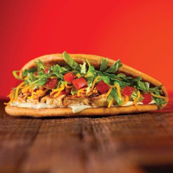 Taco John's - a taco sandwich on a wooden table - Fast Food Near Me - Peru, Indiana Taco John's - a taco sandwich on a wooden table - Fast Food Near Me - Peru, Indiana