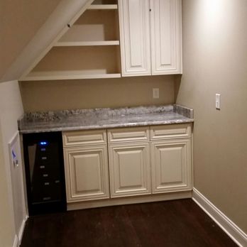 Greystone Remodeling - a kitchen with white cabinets - General Contractors Near Me