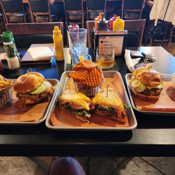Prohibition Dunedin - Left to right... Southern Deep Fried Chicken Sandwich, Pork Belly (BLT) in sourdough bread and Prohibition cheeseburger - Gastropubs Near Me - Dunedin, Florida