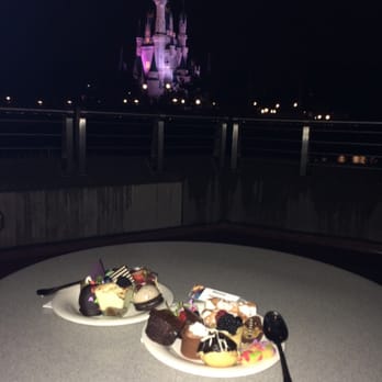 Tomorrowland Terrace Restaurant - Fireworks Dessert Party-some of the desserts and our view of the castle from our table - American Near Me - Orlando, Florida