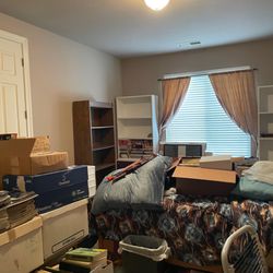 Treasures to Find Estate Sales and Liquidation - Guest room before--furniture, plenty of boxes of books, magazines and more.