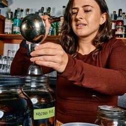 Bar West - Beverage Director Andria getting our hand-harvested Nocino ready to launch in Fall!