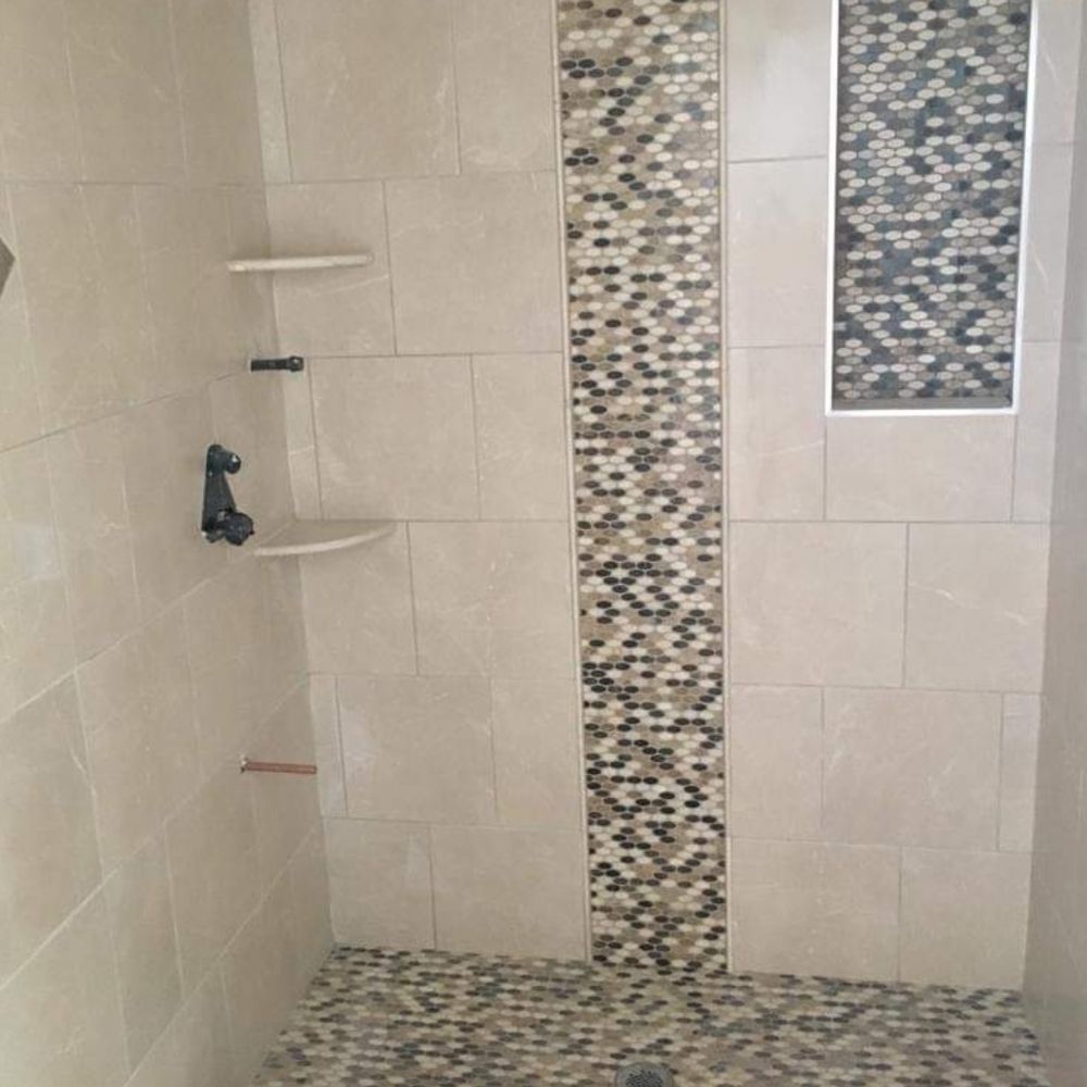 Marcelo Construction - a walk in shower with a tiled floor - Flooring Near Me Marcelo Construction - a walk in shower with a tiled floor - Flooring Near Me