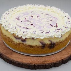 Thicc Cakes - Lemon Blueberry cheesecake with a lemon cream topping and whipped cream.