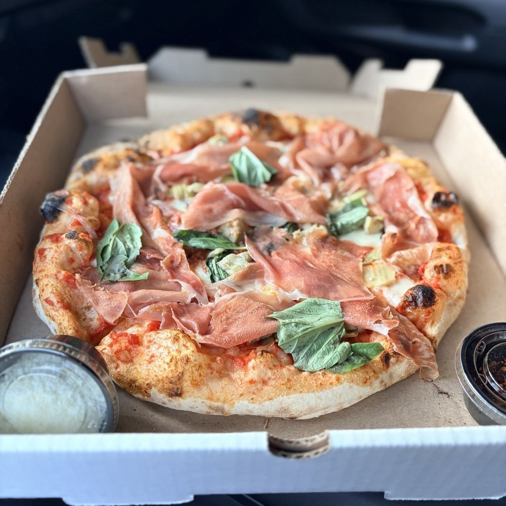 Margherita Pizza with prosciutto and artichoke added. Margherita Pizza with prosciutto and artichoke added.