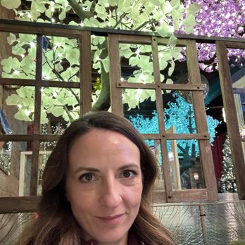 Fired Up Pizzeria - One of the indoor booths with the flowering trees in the background. - Pizza Near Me - Durango, Colorado