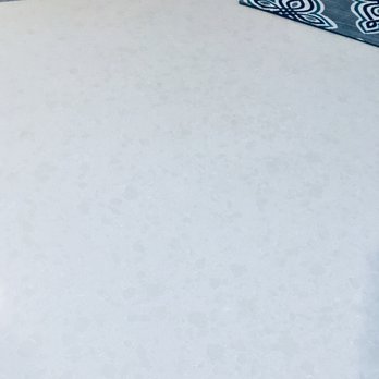 Gleeson's Modern Concepts - a bed with a blue and white comforter - General Contractors Near Me - Mckinney, Texas