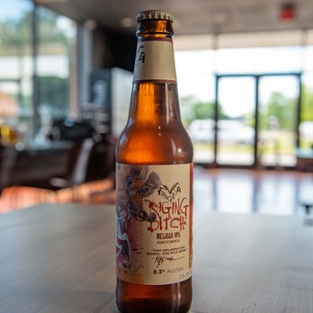 HomeSlyce - JHU - a bottle of beer on a table - Pizza Near Me - Baltimore, Maryland