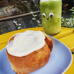 Perch Cafe and Bakery - Matcha latte with a cinnamon roll at our outdoor bistro table! Googly eyes are optional!
