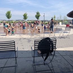 Busy and packed splash pad, people hog chairs they aren't using. Busy and packed splash pad, people hog chairs they aren't using.