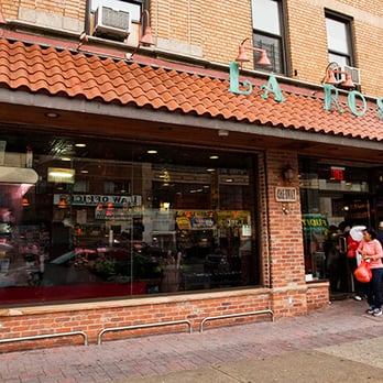 La Rosa Foods - a woman walking in front of a store - Grocery Near Me - New York, New York La Rosa Foods - a woman walking in front of a store - Grocery Near Me - New York, New York