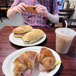 Two Costas Bakery & Deli - Taylor Ham and Cheese Breakfast sandwich and Ham and Cheese Croissant plus an iced latte
