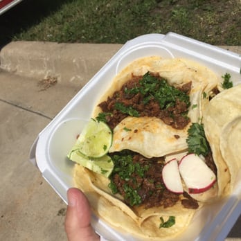 Tacos El Paraiso - a hand holding a container of tacos - Food Trucks Near Me - Minneapolis, Minnesota