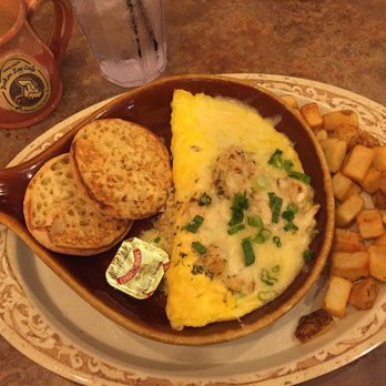 Another Broken Egg Cafe - This is the Floridian Omelette! It comes with an English muffin & a side. It's stuffed with cream cheese and topped with crab meat ! So good - Breakfast & Brunch Near Me - Panama City Beach, Florida