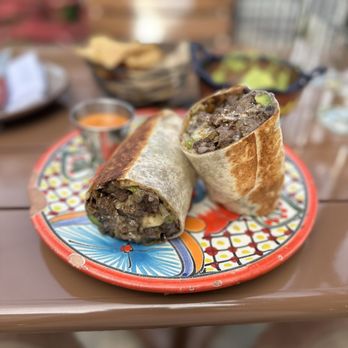 Mi Tocaya Antojeria - Steak Burrito chela-marinated, grilled skirt steak, queso chihuahua,black beans, romaine, avocado, grilled onion, banana peppers, sour cream - Mexican Near Me - Chicago, Illinois Mi Tocaya Antojeria - Steak Burrito chela-marinated, grilled skirt steak, queso chihuahua,black beans, romaine, avocado, grilled onion, banana peppers, sour cream - Mexican Near Me - Chicago, Illinois
