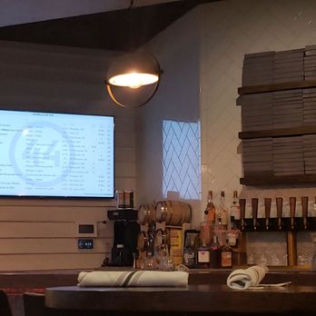44 Mills Kitchen + Tap - Monitor at the end of the bar listing local craft and domestic. - New American Near Me - Concord, North Carolina
