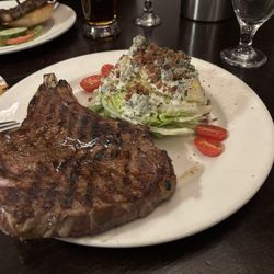 The CattleBaron Steakhouse & Bar - Cowboy Ribeye with wedge salad.