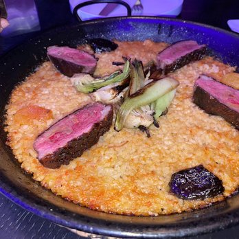 MAD - PATO PAELLA duck breast magret, baby chok choy, dried apricots and calvados-soaked prunes - 45/85 - Spanish Near Me - Houston, Texas