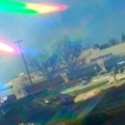 Merlins Ace Hardware - view of ace hardware store from outside looking through fireworks rainbow glasses! : )
