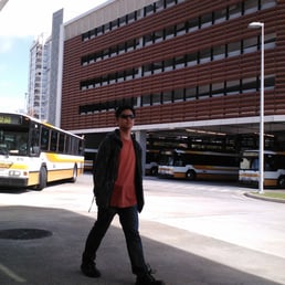 woops, that guy got in the middle of the pic. The busses wait in the huge unloading area of the transit center in the shade. woops, that guy got in the middle of the pic. The busses wait in the huge unloading area of the transit center in the shade.