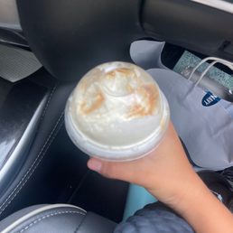a hand holding a cup of coffee